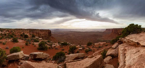 Scenic Panoramic View of American Landscape and Red Rock Mountains in Desert Canyon. Cloudy Sunset Sky. Canyonlands National Park. Utah, United States. Nature Background Panorama