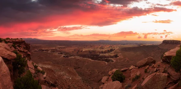 Scenic Panoramic View of American Landscape and Red Rock Mountains in Desert Canyon. Colorful Sunset Sky Art Render. Canyonlands National Park. Utah, United States. Nature Background Panorama