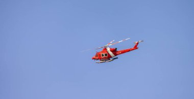 Ucluelet, Vancouver Island, British Columbia, Canada - July 12, 2022: Canadian Coast Garde Helicopter taking of and flying during a sunny summer morning.