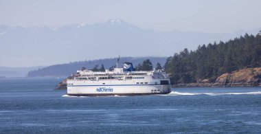 Gulf Islands, British Columbia, Canada - July 14, 2022: BC Ferries Passing By the islands on the West Coast of Pacific Ocean.