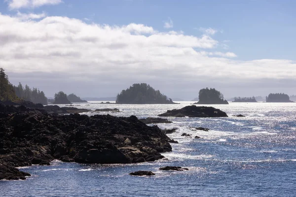 Rugged Rocks on a rocky shore on the West Coast of Pacific Ocean. Summer Morning Sky. Ucluelet, Vancouver Island, British Columbia, Canada. Nature Background