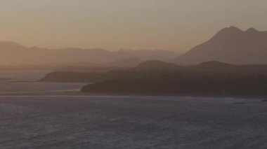 Waves on the Pacific Ocean on a sandy and rocky beach. West Coast. Sunny Summer. Cox Bay, Tofino, Vancouver Island, BC, Canada. Canadian Nature Background.