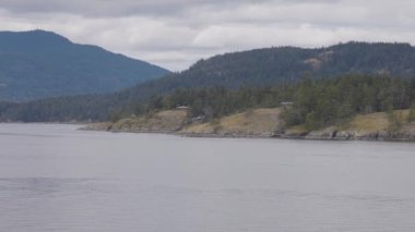 Islands surrounded by ocean and mountains. Summer Season. Gulf Islands near Vancouver Island, British Columbia, Canada. Canadian Landscape.