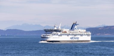 Gulf Islands, British Columbia, Canada - July 14, 2022: BC Ferries Passing By the islands on the West Coast of Pacific Ocean.