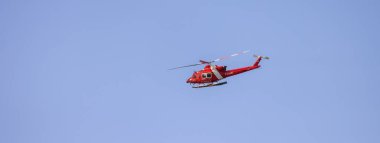 Ucluelet, Vancouver Island, British Columbia, Canada - July 12, 2022: Canadian Coast Garde Helicopter taking of and flying during a sunny summer morning.
