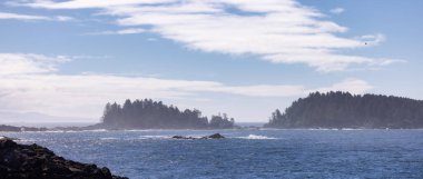 Rugged Rocks on a rocky shore on the West Coast of Pacific Ocean. Summer Morning Sky. Ucluelet, Vancouver Island, British Columbia, Canada. Nature Background