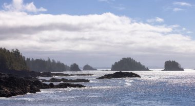 Rugged Rocks on a rocky shore on the West Coast of Pacific Ocean. Summer Morning Sky. Ucluelet, Vancouver Island, British Columbia, Canada. Nature Background