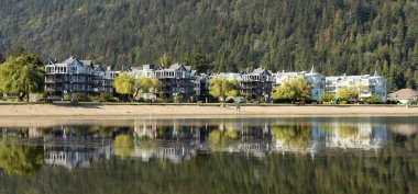 Vacation Homes by the lake and sandy beach. Sunny Summer Morning. Harrison Hot Springs, British Columbia, Canada.