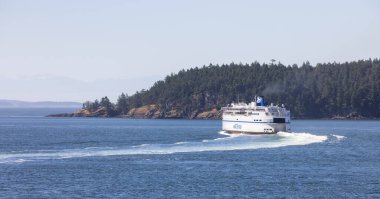 Gulf Islands, British Columbia, Canada - July 14, 2022: BC Ferries Passing By the islands on the West Coast of Pacific Ocean.