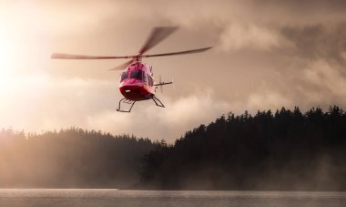 Helicopter Flying over the West Coast Pacific Ocean. Extreme Adventure Composite. 3D Rendering Heli. Background Image from Tofino, Vancouver Island, British Columbia, Canada. Dramatic Sunset