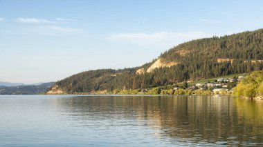 Peaceful View of Wood Lake with Reflection on the water and mountains in background. Lake Country, Okanagan, British Columbia, Canada. Sunrise