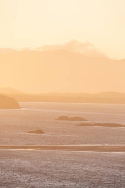 Waves on the Pacific Ocean on a sandy and rocky beach. West Coast. Sunny Summer. Cox Bay, Tofino, Vancouver Island, BC, Canada. Canadian Nature Background.