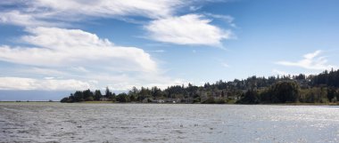 Residential Homes on the West Coast of Pacific Ocean. Sunny and Cloudy Summer Day. Victoria, Vancouver Island, British Columbia, Canada.