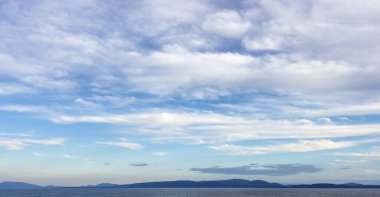 Cloudy Cloudscape during sunny summer Day on the West Coast of Pacific Ocean. British Columbia, Canada. Sunset Sky