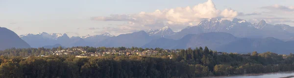 Residential Homes in a modern city with mountain peaks in background. Mary Hill, Port Coquitlam, Vancouver, British Columbia, Canada.