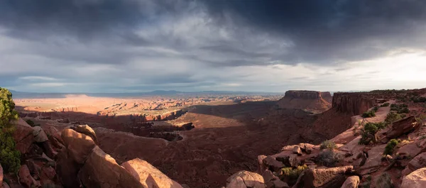 Scenic Panoramic View of American Landscape and Red Rock Mountains in Desert Canyon. Cloudy Sunset Sky. Canyonlands National Park. Utah, United States. Nature Background Panorama