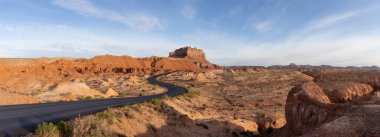 Scenic Road in Red Rock Mountains in the Desert at Colorful Sunrise. Spring Season. Goblin Valley State Park. Utah, United States. Nature Background Panorama