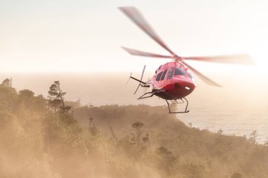 Helicopter Flying over the West Coast Pacific Ocean. Extreme Adventure Composite. 3D Rendering Heli. Background Image from Tofino, Vancouver Island, British Columbia, Canada. Dramatic Sunset