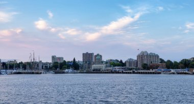 Victoria, Vancouver Island, British Columbia, Canada - September 3, 2022: Buildings, Marina and HIstoric Landmarks in Downtown Capital City during colorful sunrise.
