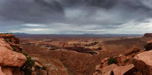 Scenic Panoramic View of American Landscape and Red Rock Mountains in Desert Canyon. Cloudy Sunset Sky. Canyonlands National Park. Utah, United States. Nature Background Panorama