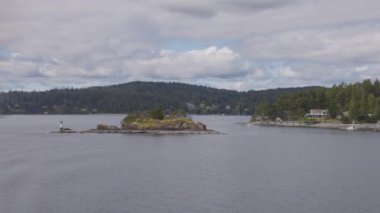 Islands surrounded by ocean and mountains. Summer Season. Gulf Islands near Vancouver Island, British Columbia, Canada. Canadian Landscape.
