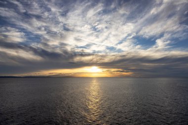 Cloudy Cloudscape during sunny summer Day on the West Coast of Pacific Ocean. British Columbia, Canada. Sunset Sky
