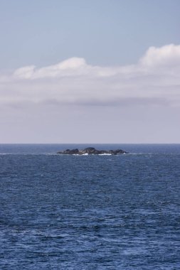 Rugged Rocks on a rocky shore on the West Coast of Pacific Ocean. Summer Morning Sky. Ucluelet, Vancouver Island, British Columbia, Canada. Nature Background
