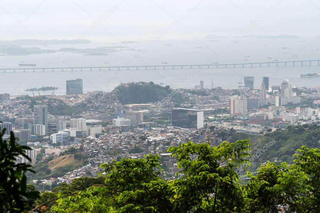 Beautiful view to city buildings from green rainforest mountain in Rio de Janeiro, Brazil