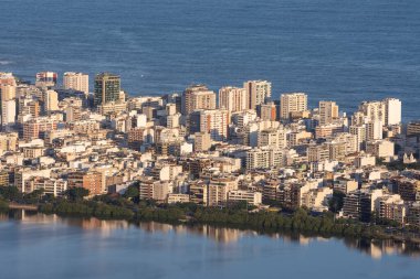 Beautiful view to city buildings, lake and ocean from Tijuca Park, Rio de Janeiro, Brazil