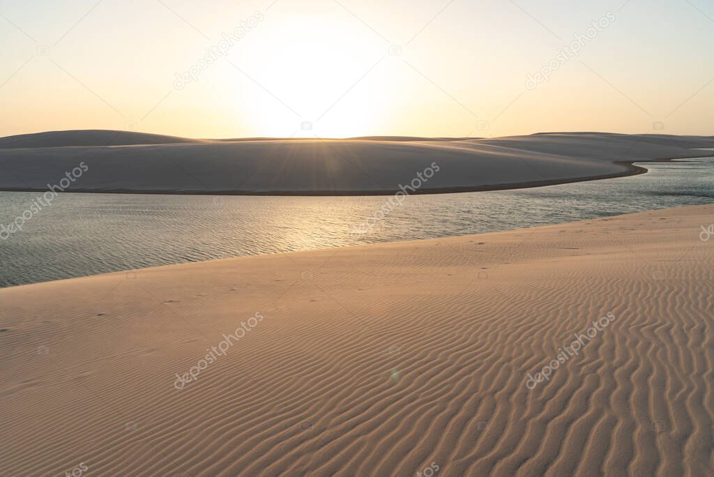 Beautiful sunset view to rainwater lagoon and sand texture on dunes in Lenois Maranhenses, Maranhao State, Brazil.