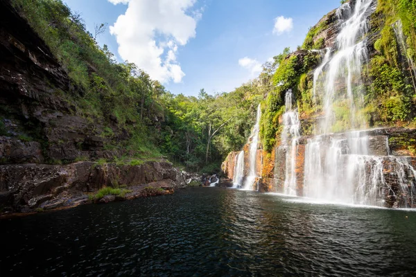 Beautiful view to big wild green rocky waterfall in Chapada dos Veadeiros, Gois State, Central Brazil.