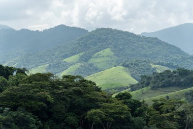 View to beautiful green rainforest mountains and pasture fields, countryside of Rio de Janeiro, Brazil