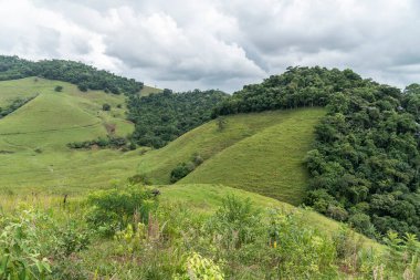 View to beautiful green rainforest mountains and pasture fields, countryside of Rio de Janeiro, Brazil
