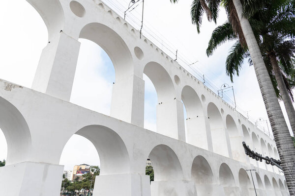 Beautiful view to white old historic aqueduct in downtown Lapa district, Rio de Janeiro, Brazil