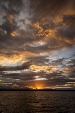 Beautiful sunset view to orange clouds and water in Parnaiba River Delta, Maranho State, Brazil.