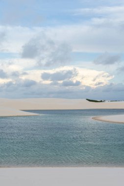 Beautiful view to blue rainwater lagoon and white sand dunes in Lenis Maranhenses, Maranho State, Brazil.
