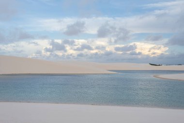 Beautiful view to blue rainwater lagoon and white sand dunes in Lenis Maranhenses, Maranho State, Brazil.
