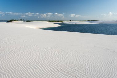 Beautiful view to blue rainwater lagoon and white sand dunes in Lenis Maranhenses, Maranho State, Brazil.