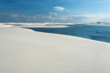 Beautiful view to blue rainwater lagoon and white sand dunes in Lenis Maranhenses, Maranho State, Brazil.