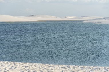 Beautiful view to blue rainwater lagoon and white sand dunes in Lenis Maranhenses, Maranho State, Brazil.