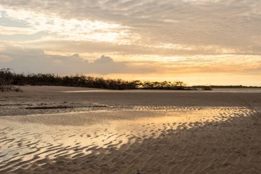 Beautiful view to sunset with clouds in Atins Beach, Lenis Maranhenses, Maranho State, Brazil.