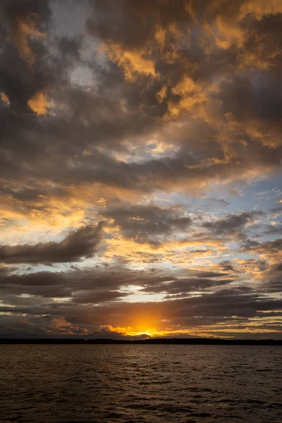 Beautiful sunset view to orange clouds and water in Parnaiba River Delta, Maranho State, Brazil.