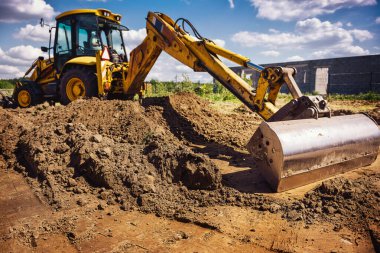 Ev inşaatındaki kazıcı - modern ev için temeller kazıyor