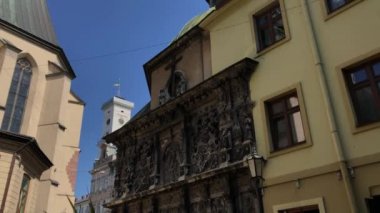 Boim Chapel outside in far away Ratusha with flag of Ukraine. UNESCO World Heritage Site In Lviv, Ukraine.