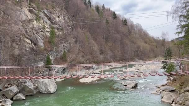 Suspension Bridge Mountain River Surrounded Rocks Early Spring — Stok video