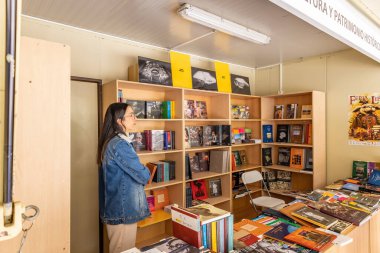 Huelva, Spain - April 24, 2022: Stand of 46th edition of the Book Fair located in the central Plaza de las Monjas (Square of the Nuns) of the city of Huelva, Andalusia, Spain