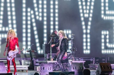 Huelva, Spain - August 1, 2022: The singer Mario Vaquerizo with the band Nancys Rubias, a Spanish musical group of electronic, pop, dance, and glam, in a concert at the Huelva Colombian festival