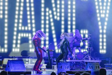 Huelva, Spain - August 1, 2022: The singer Mario Vaquerizo with the band Nancys Rubias, a Spanish musical group of electronic, pop, dance, and glam, in a concert at the Huelva Colombian festival