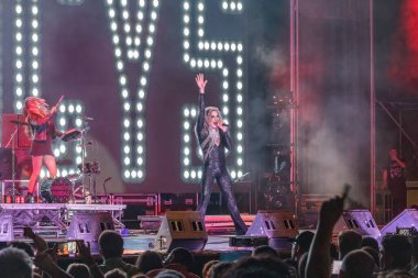 Huelva, Spain - August 1, 2022: The singer Mario Vaquerizo with the band Nancys Rubias, a Spanish musical group of electronic, pop, dance, and glam, in a concert at the Huelva Colombian festival