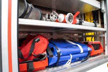 Fire truck equipment inside back of the car. 